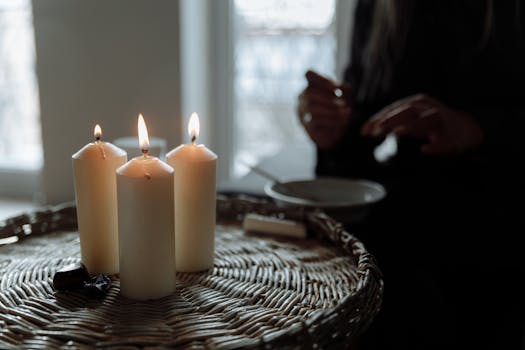 A tranquil indoor scene featuring lit candles on a woven basket, perfect for meditation and relaxation.